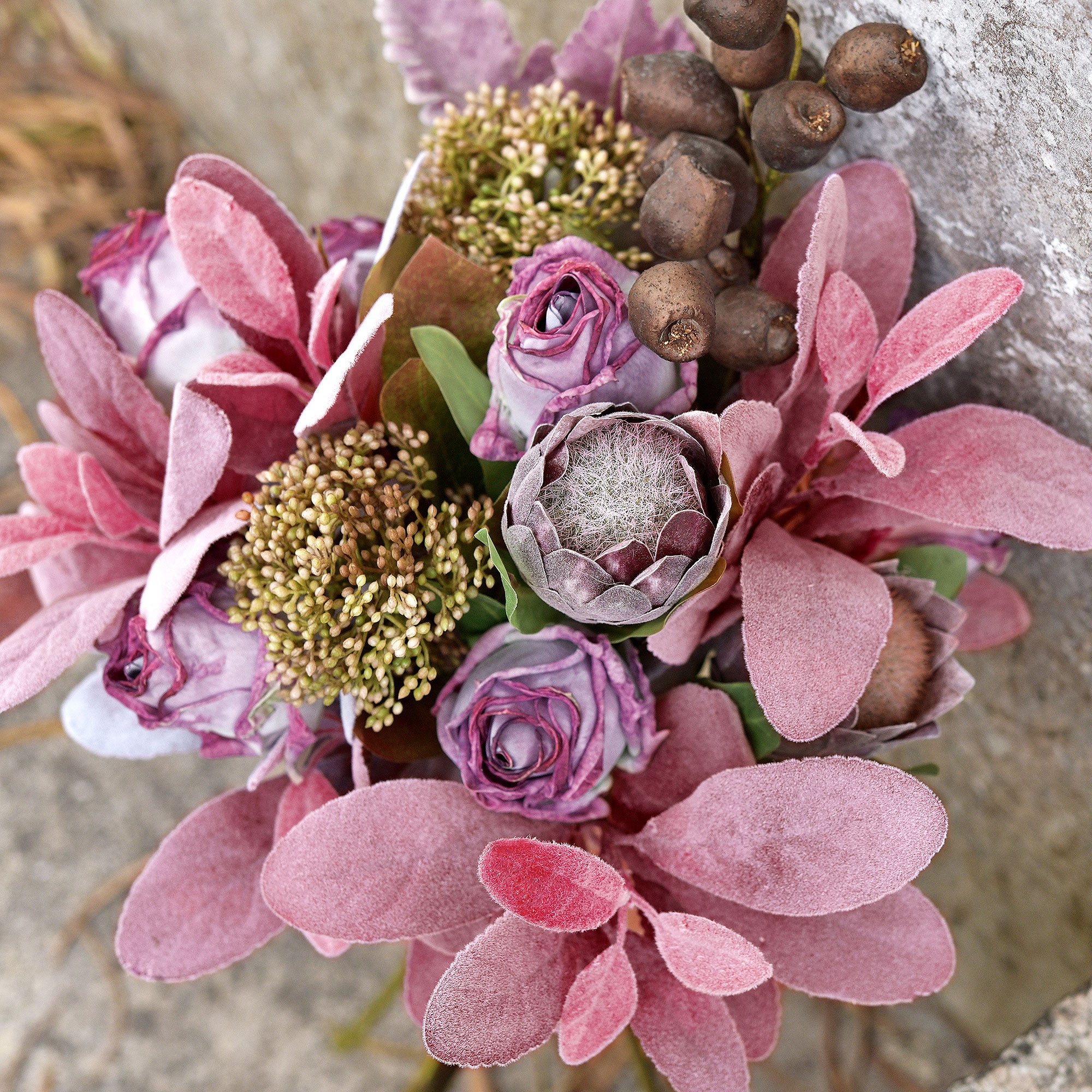 Shades of pink poenies, lambs ear and lavander are planted in a beautiful wall hanger vase. A farmhouse burlap outlets mesh bow adorns this vase.