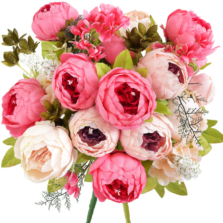 Vibrant artificial peony bouquet with shades of coral, blush pink, cream, and ivory, featuring real-touch silk petals and lush greenery.