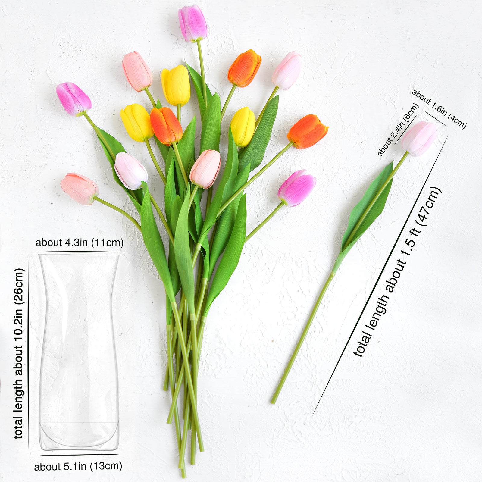 A bouquet of artificial tulips in vibrant orange, yellow, pink, and fuchsia hues displayed with a foldable clear vase; realistic stems and blooms in a lifelike arrangement with measurements.
