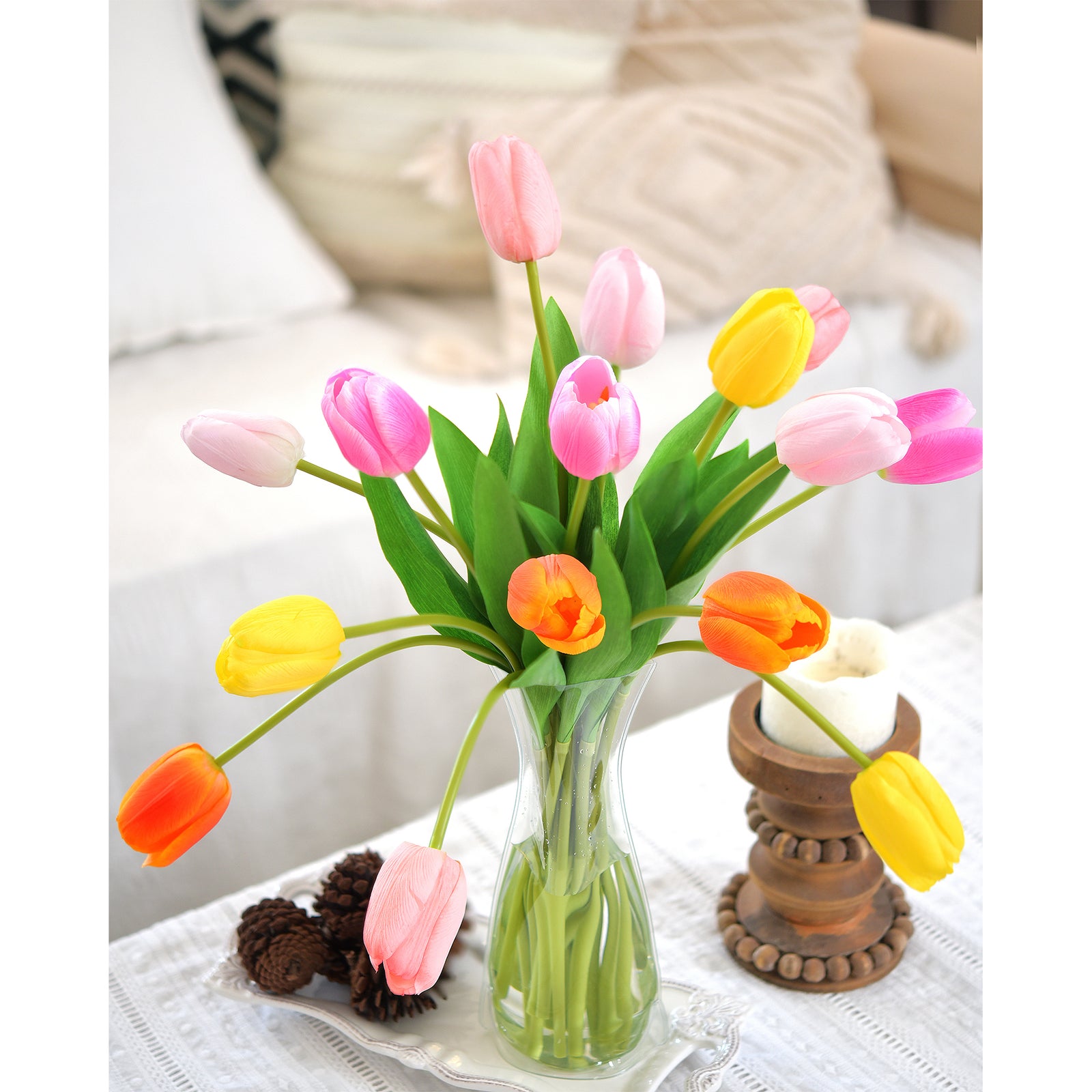 Artificial tulips displayed on a tabletop with decor accents, highlighting a fresh and cheerful arrangement.
