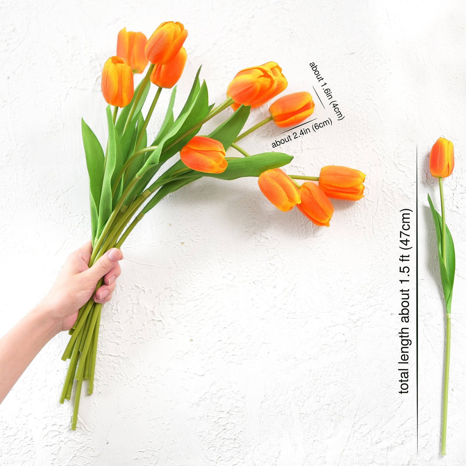 Hand holding vibrant orange artificial tulip stems with measurement details displayed.