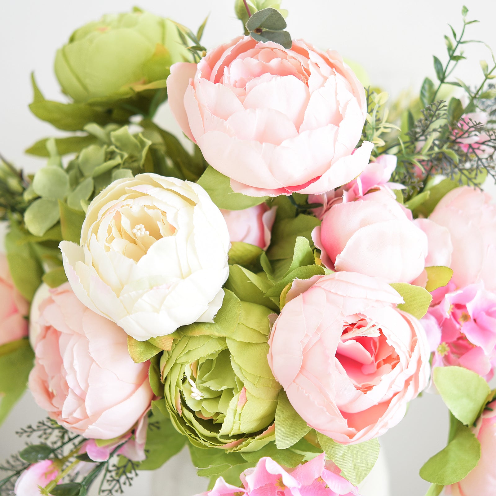 op view of artificial peonies and hydrangeas in cream beige, moss green, and blush, showing handcrafted petals and realistic floral arrangement.