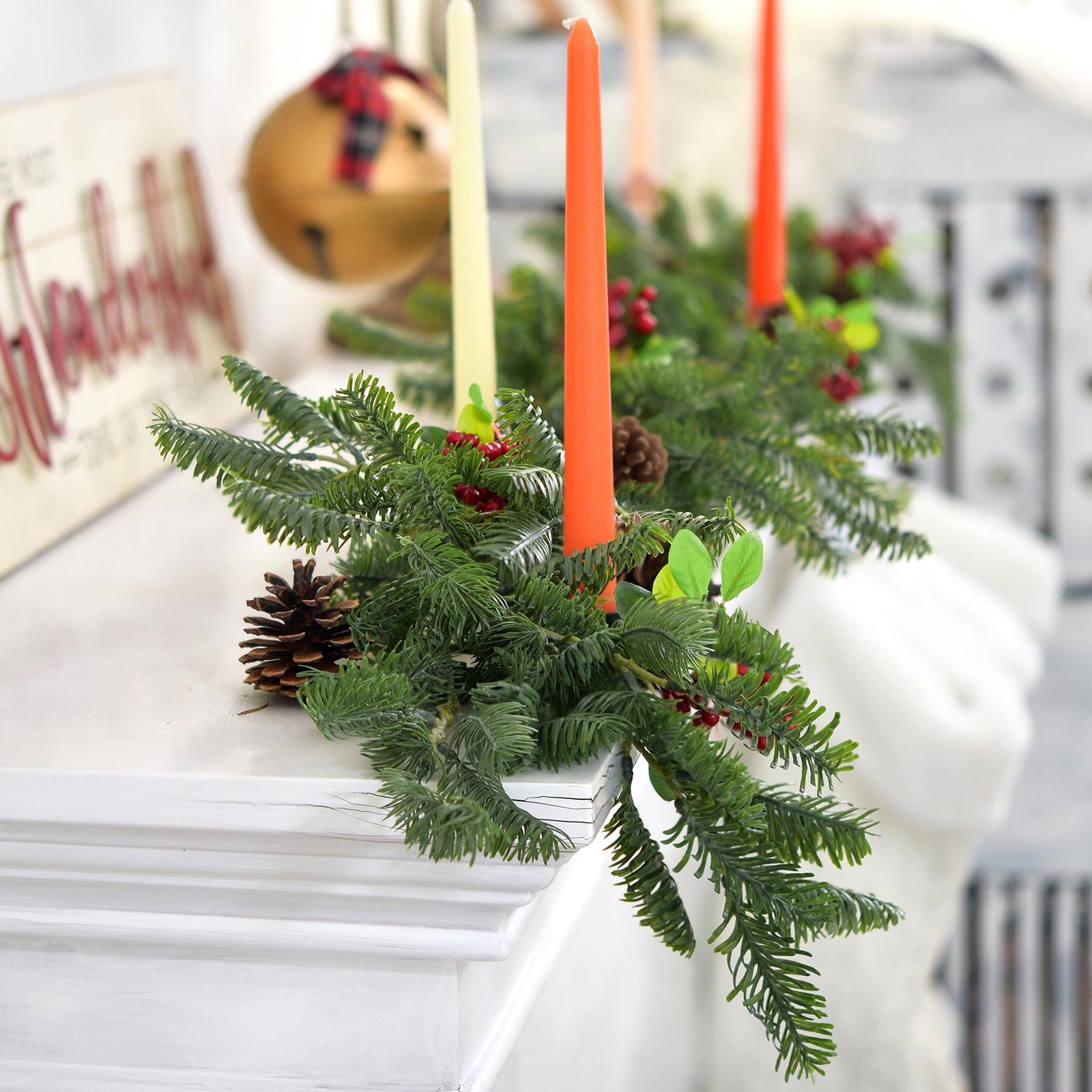 Soft-touch faux pine stems arranged with candles for a cozy, winter-inspired centerpiece