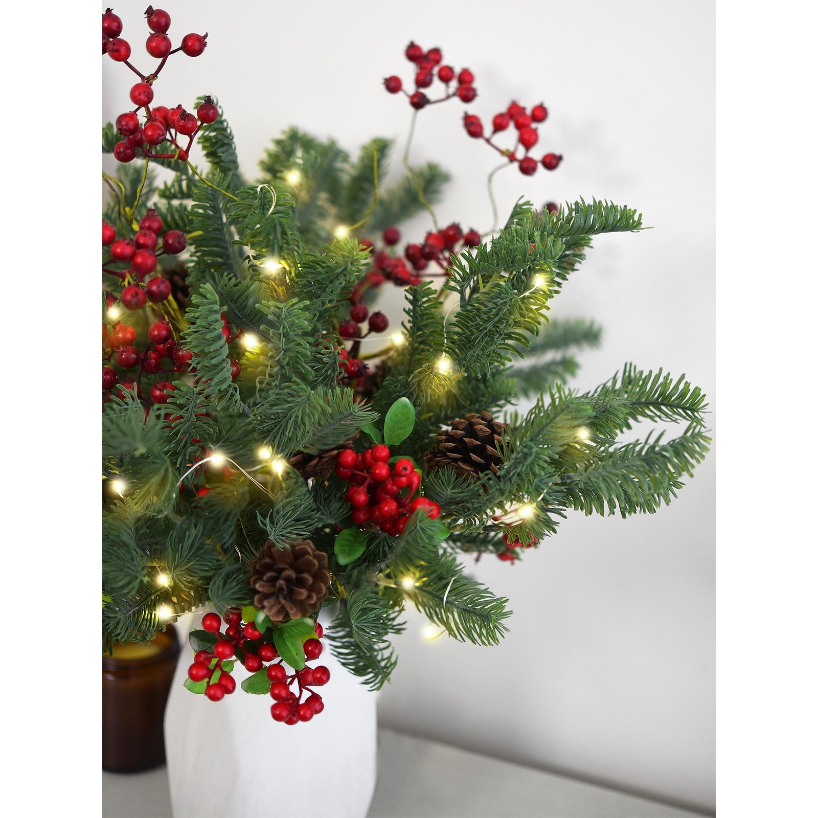 Soft-touch faux pine branches in a modern vase, perfect for festive indoor décor