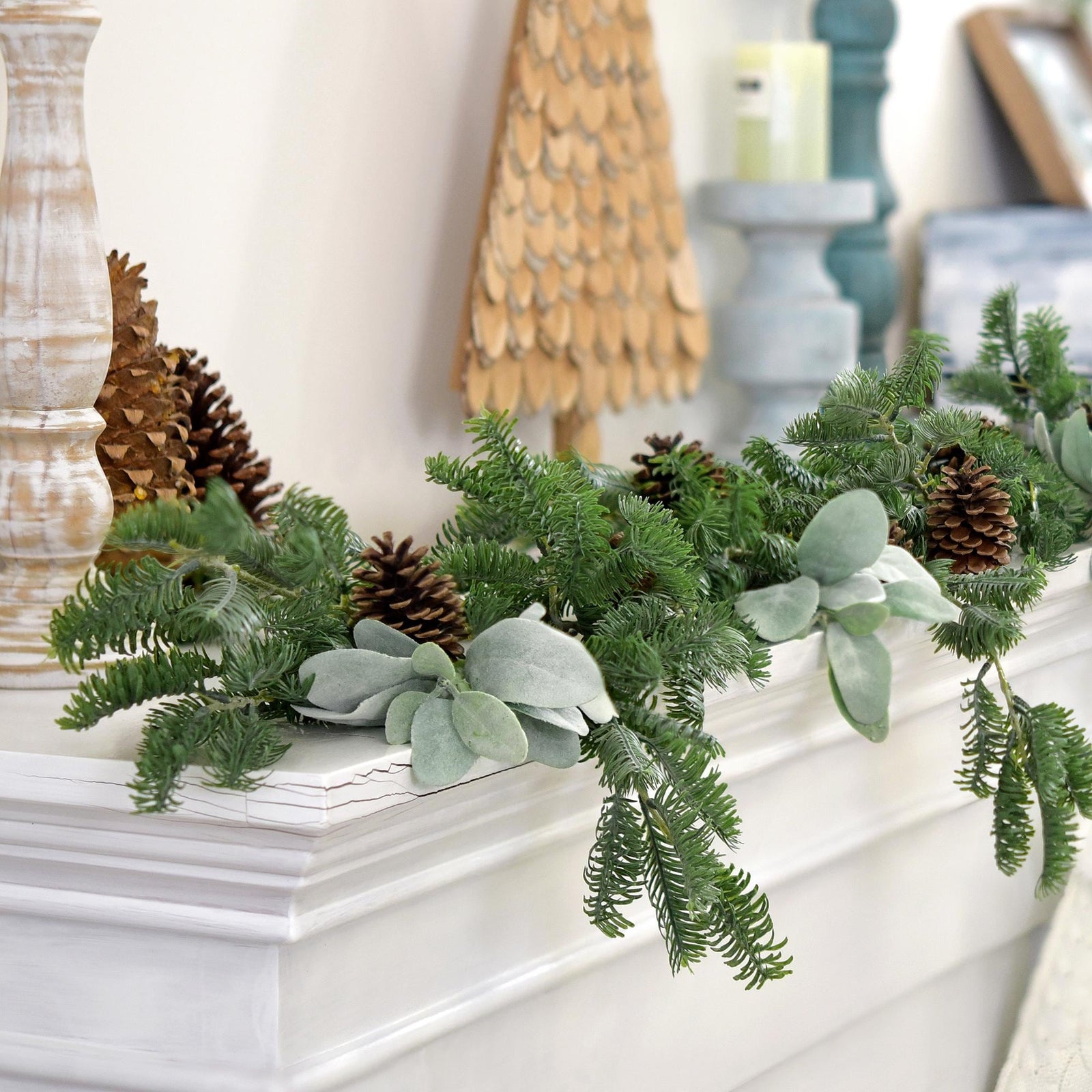 Soft-touch faux pine garland draped over a rustic mantle for a festive winter look