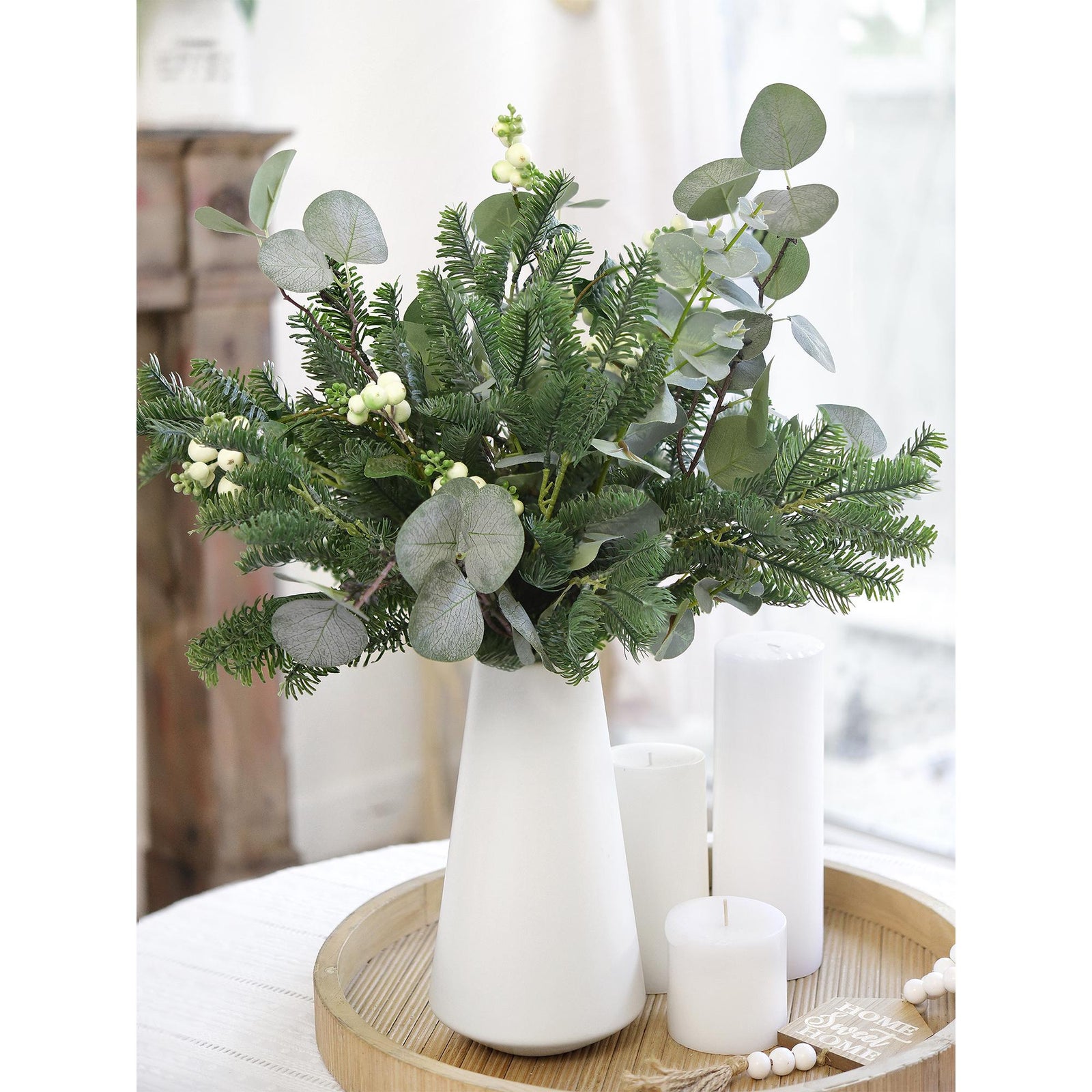 Soft-touch faux pine stems in a white vase, perfect for holiday table centerpieces