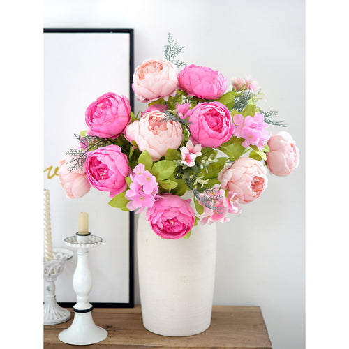 Lifelike silk peony bouquet in bright pink and blush arranged in a tall white vase, styled beside a mirror for a clean, modern look.