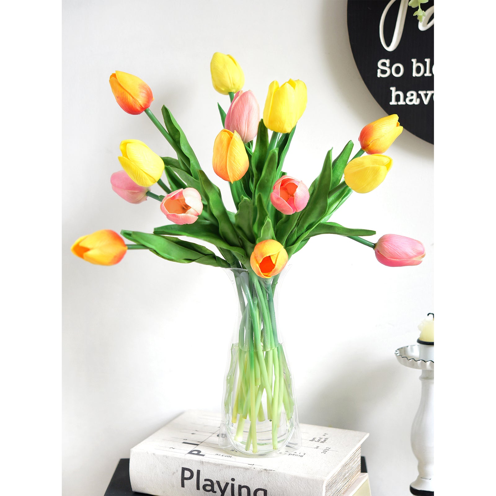 Real-touch artificial tulips in vibrant yellow, orange, and pink hues arranged in a clear glass-like vase, perfect for home décor or gifting.

