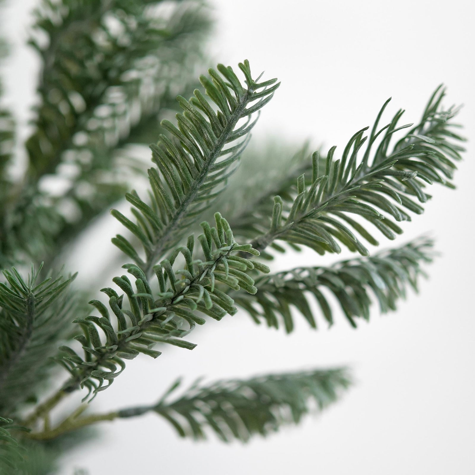 Close-up of realistic soft-touch faux pine branches with lush pine needles