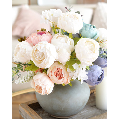 Vibrant multicolor peony arrangement featuring pastel tones, displayed in a decorative vase for weddings or seasonal décor