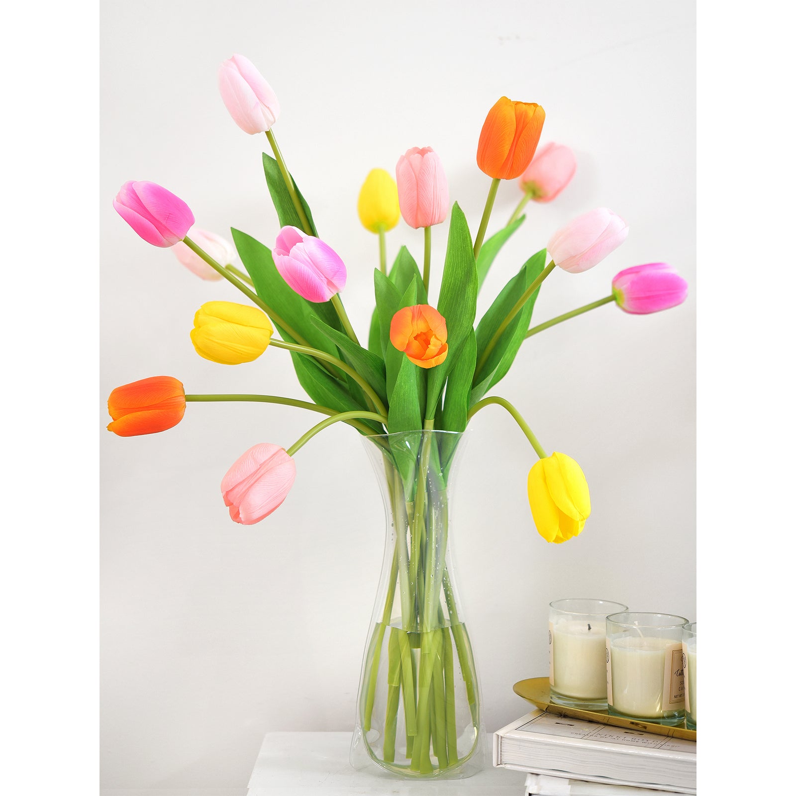 Vibrant artificial tulip bouquet in orange, yellow, and pink tones with lifelike details and lush green stems.
